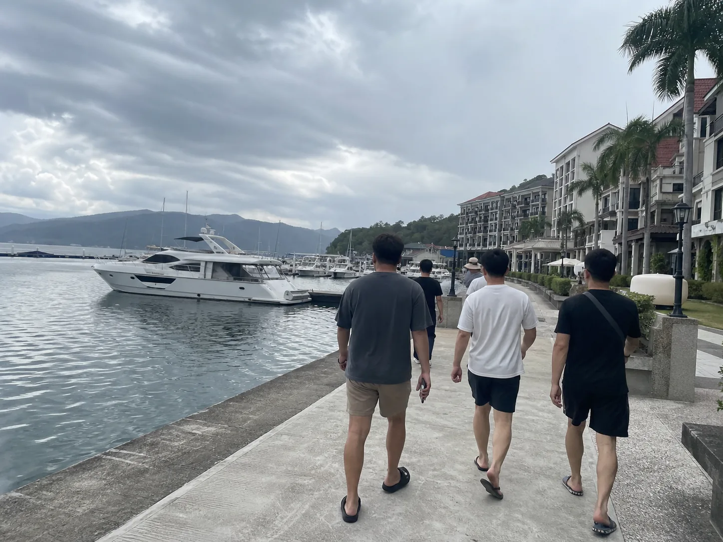 Subic Bay marina walk with adult travelers photographed from behind